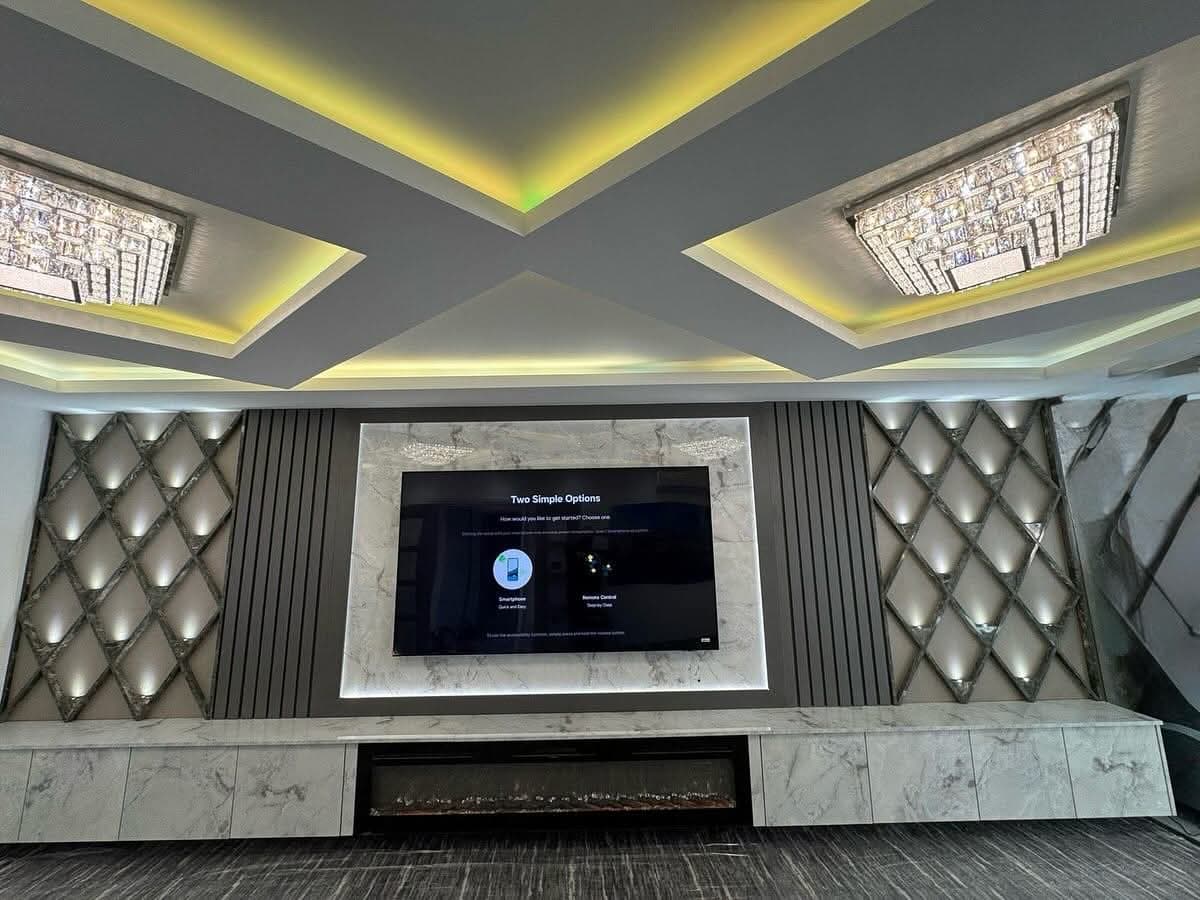 Diamond Panel Wall with Marble Fireplace and Tall Cupboards
