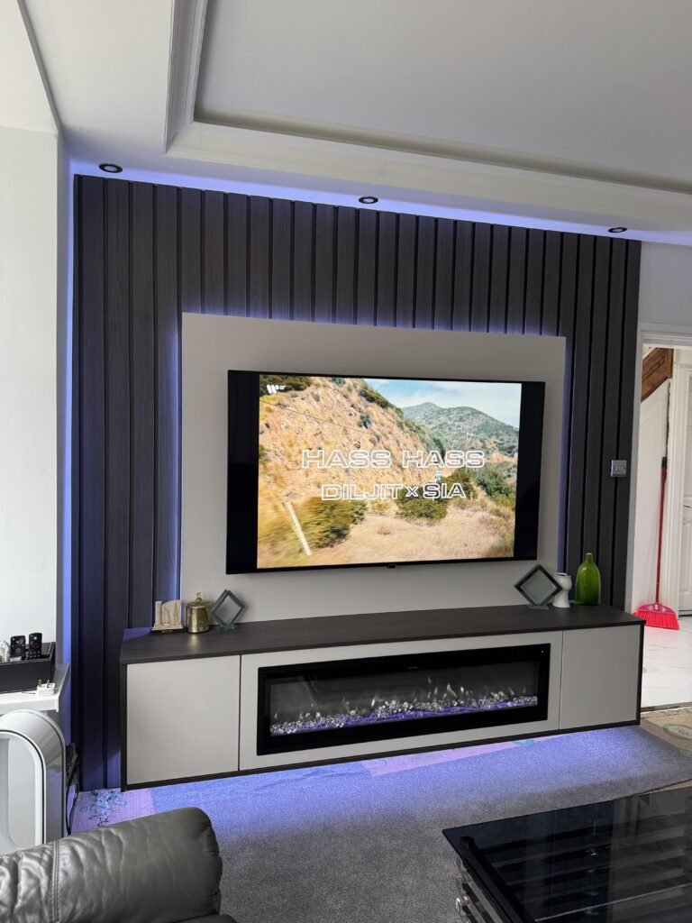 TV Displaying Mountain Landscape Scene in a Modern Media Wall Setup