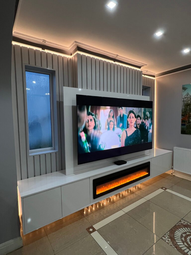 TV screen showing a formal gathering with elegantly dressed individuals, displayed on a custom-built multimedia wall unit.